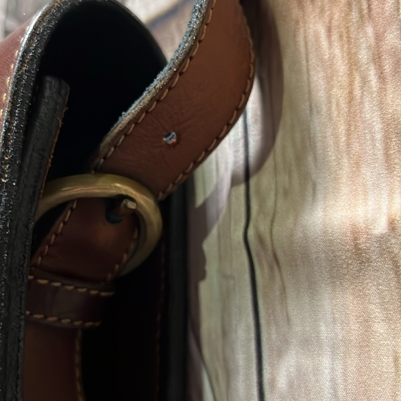 brown leather and features the gold-toned horsebit hardware.  B36 - Picture 4 of 9